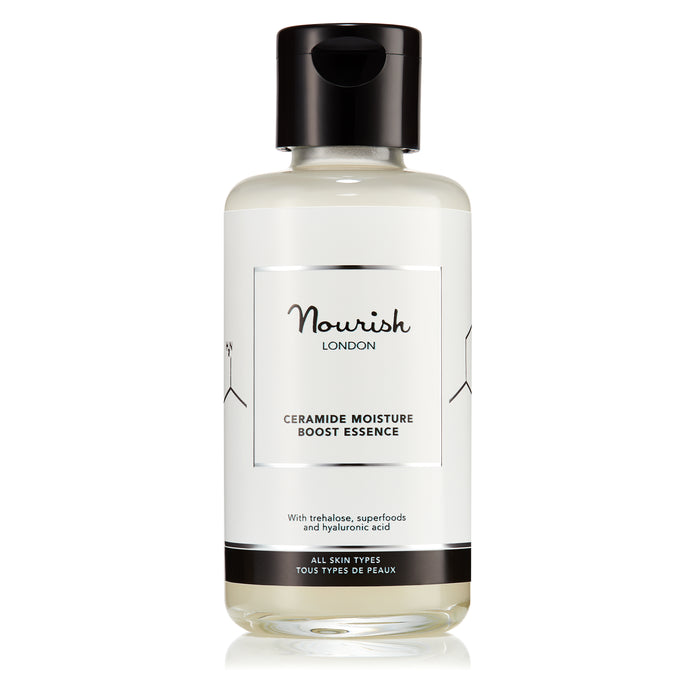 A clear bottle of Nourish London Ceramide Moisture Boost Essence with a black cap, displayed against a white background.
